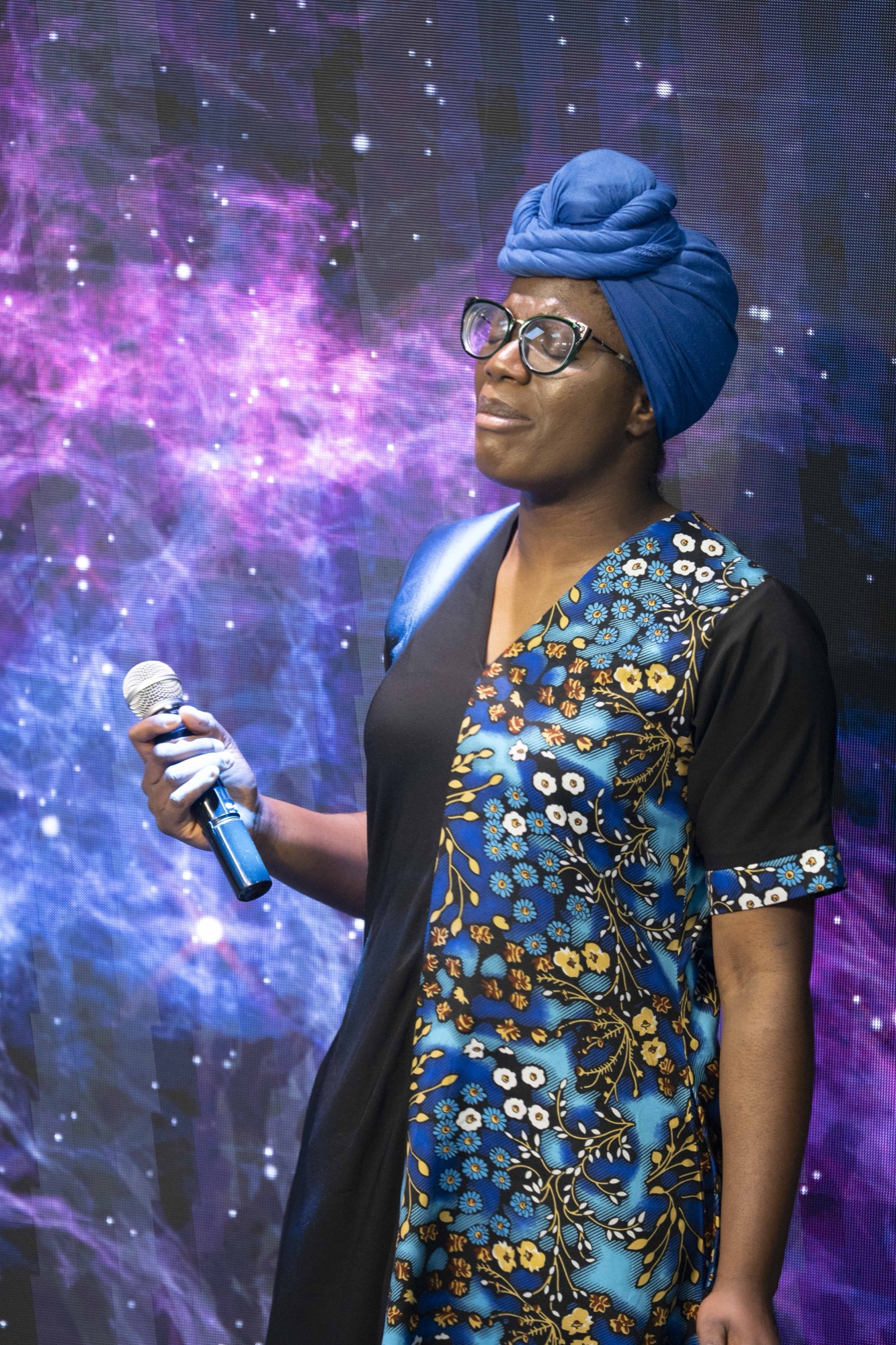 A worshipper before a cosmic starfield