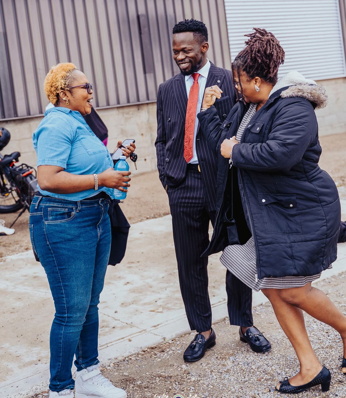 Church members warmly welcoming and chatting with one another outside after a Sunday service at Kingdom Stars Assembly in Guelph
